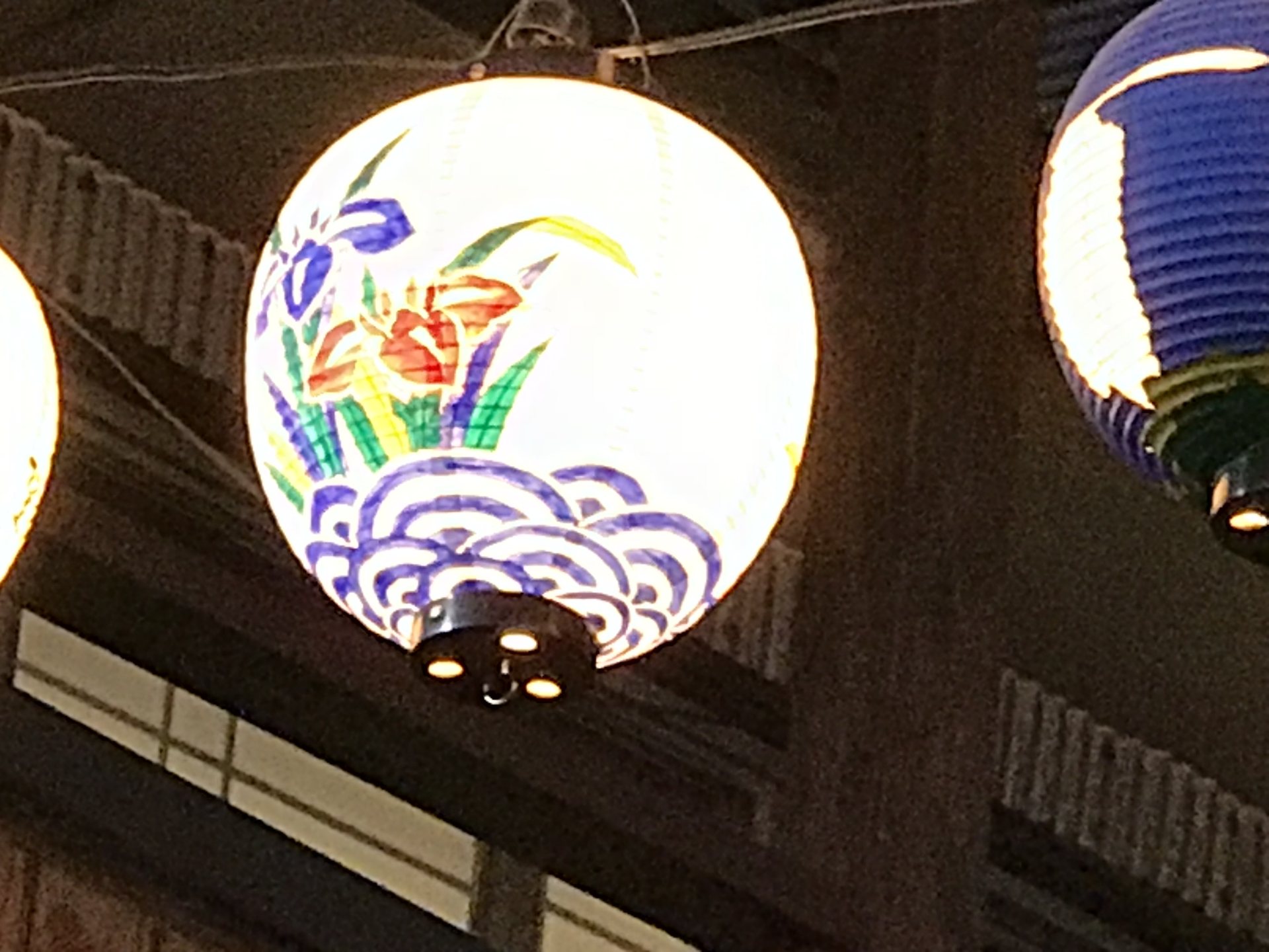 伊万里横丁の提灯に描かれた花と青い波のような絵柄の近影