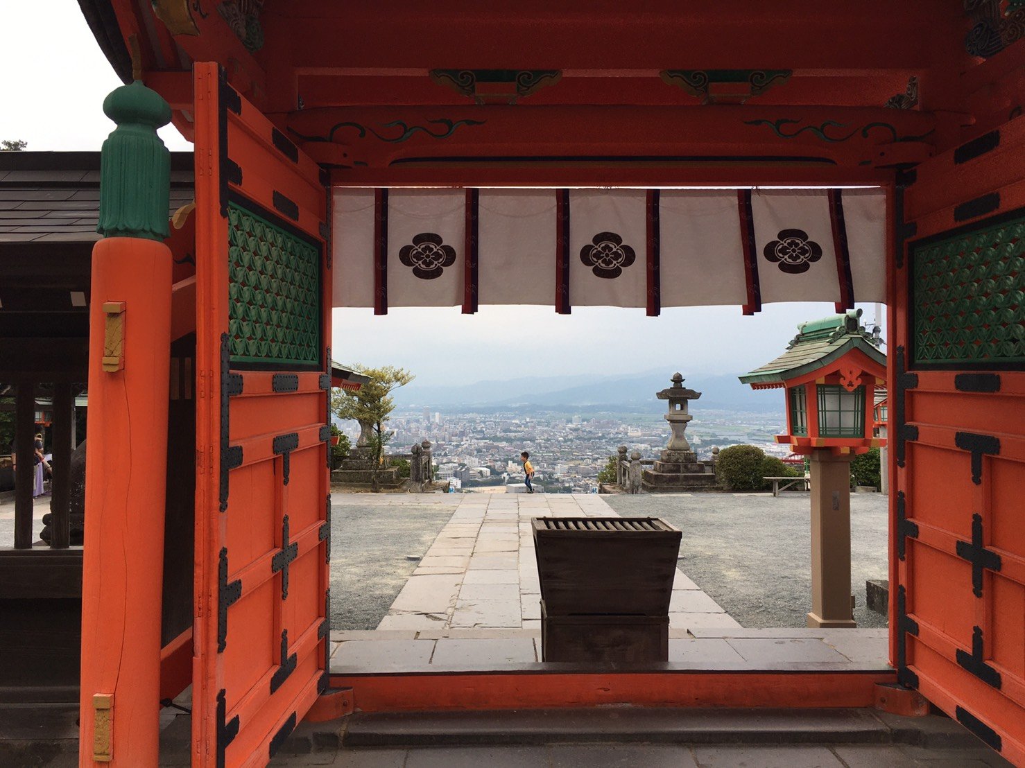 高良大社の朱色の門の内側から筑後平野を眺めた風景